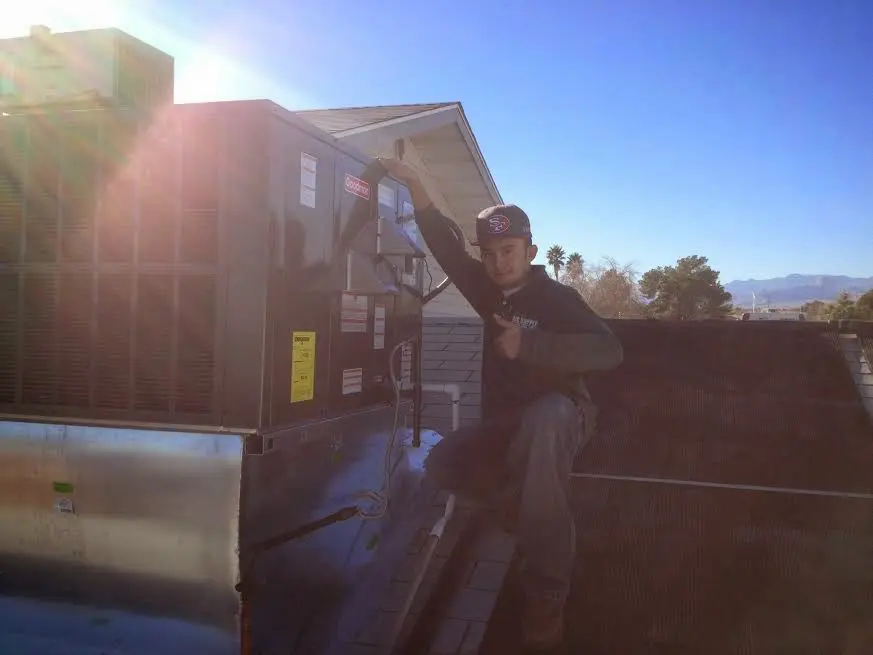 HVAC technician performing Heat Pump Repair on a rooftop unit in West Columbia